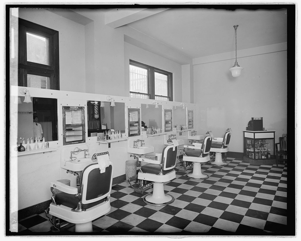 Interior da barbearia com piso antigo e espelhos